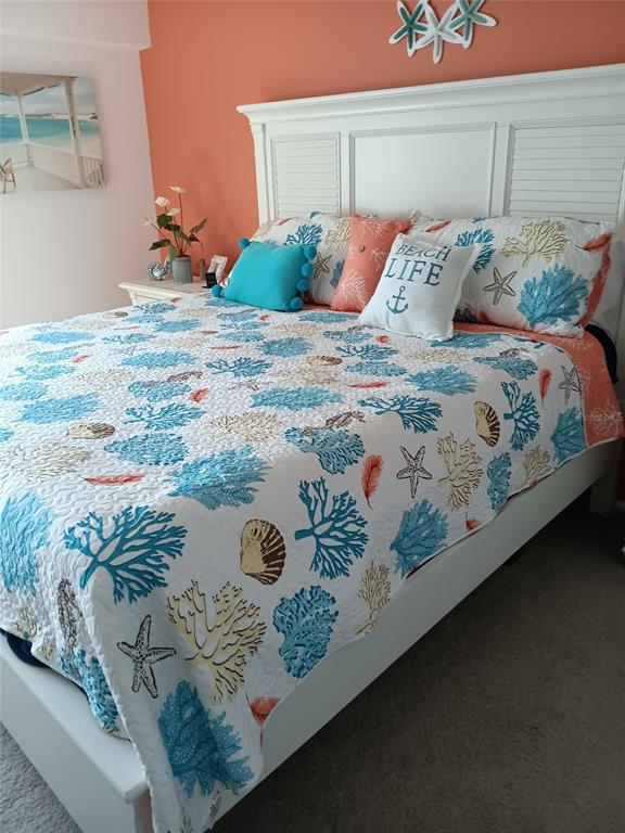 14800 Walsingham Road, Unit 1215 Largo, FL 33774 - Photo 19 of 34 a bedroom with a bed and a painting on the wall