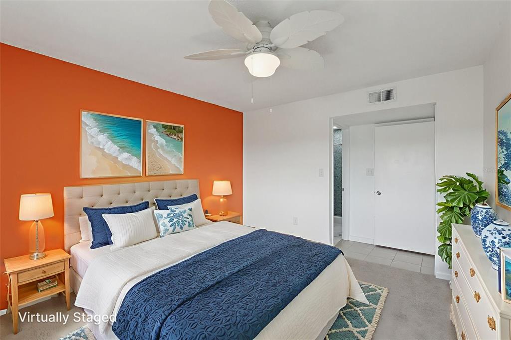 14800 Walsingham Road, Unit 1215 Largo, FL 33774 - Photo 21 of 34 a bedroom with a bed and a potted plant