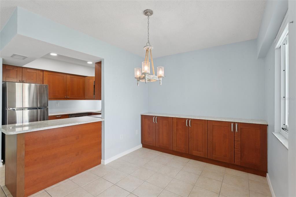 14800 Walsingham Road, Unit 1215 Largo, FL 33774 - Photo 5 of 34 a view of a kitchen with stainless steel appliances granite countertop cabinets and a wooden floor