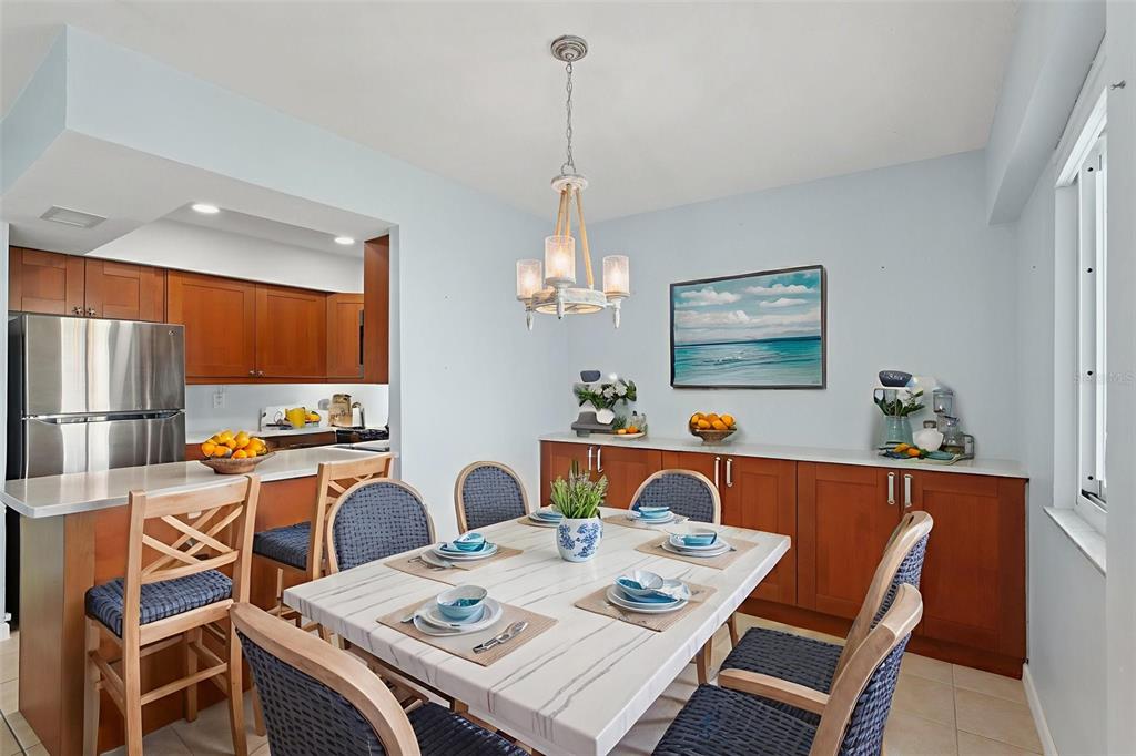 14800 Walsingham Road, Unit 1215 Largo, FL 33774 - Photo 6 of 34 a view of a dining room with furniture a rug and wooden floor
