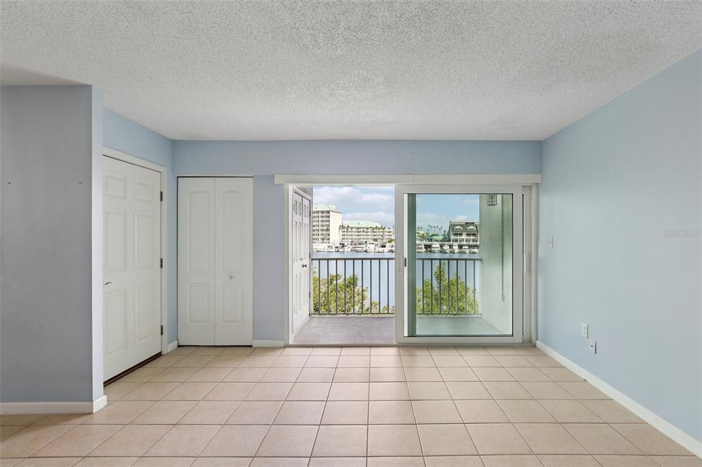 14800 Walsingham Road, Unit 1215 Largo, FL 33774 - Photo 9 of 34 a view of an empty room with glass door