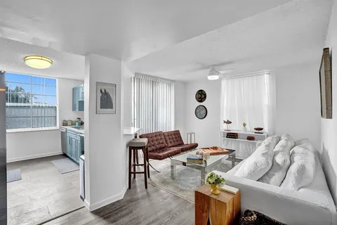 a living room with furniture and wooden floor