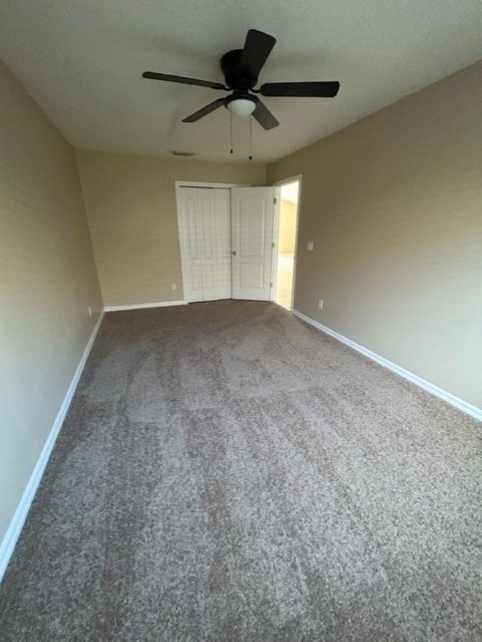 625 Nautical Way St. Augustine, FL 32080 - Photo 15 of 18 a view of an empty room and a ceiling fan & window