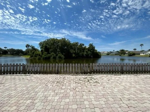 a view of swimming pool with a lake in the background