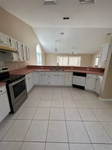 a kitchen with cabinets and appliances