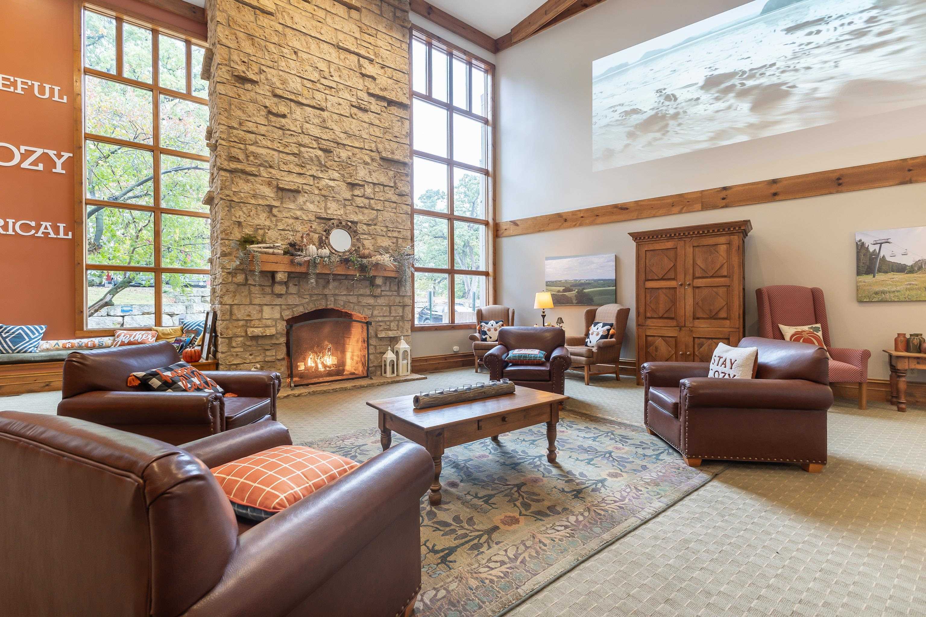 5129 West Longhollow Road Galena, IL 61036 - Photo 19 of 20 a living room with furniture a fireplace and a large window
