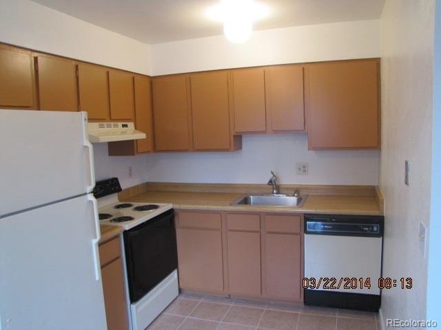 9340 West 49th Avenue, Unit 218 Wheat Ridge, CO 80033 - Photo 1 of 8 a kitchen with a sink a stove and a refrigerator
