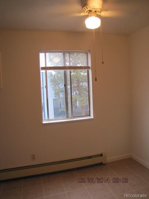 9340 West 49th Avenue, Unit 218 Wheat Ridge, CO 80033 - Photo 2 of 8 an empty room with a window