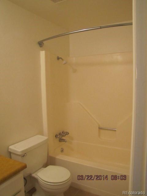 9340 West 49th Avenue, Unit 218 Wheat Ridge, CO 80033 - Photo 6 of 8 a white toilet sitting next to a bath tub