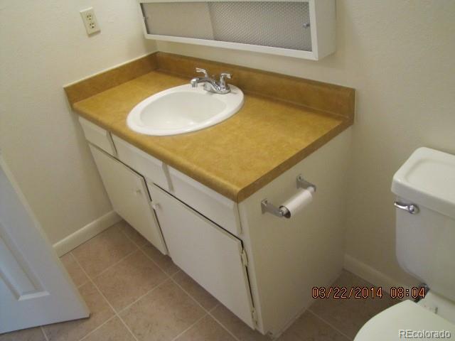 9340 West 49th Avenue, Unit 218 Wheat Ridge, CO 80033 - Photo 7 of 8 a bathroom with a sink and a toilet