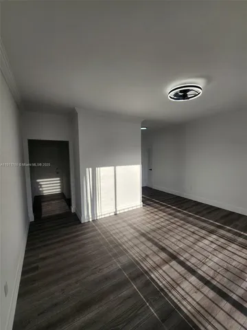 a view of a room with wooden floor