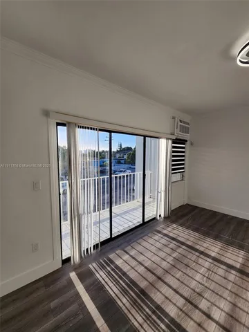 a view of a livingroom with wooden floor and stairs