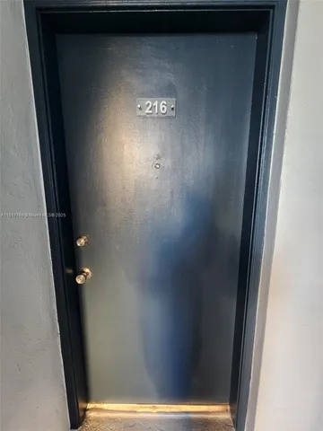 a view of a hallway with wooden floor and closet