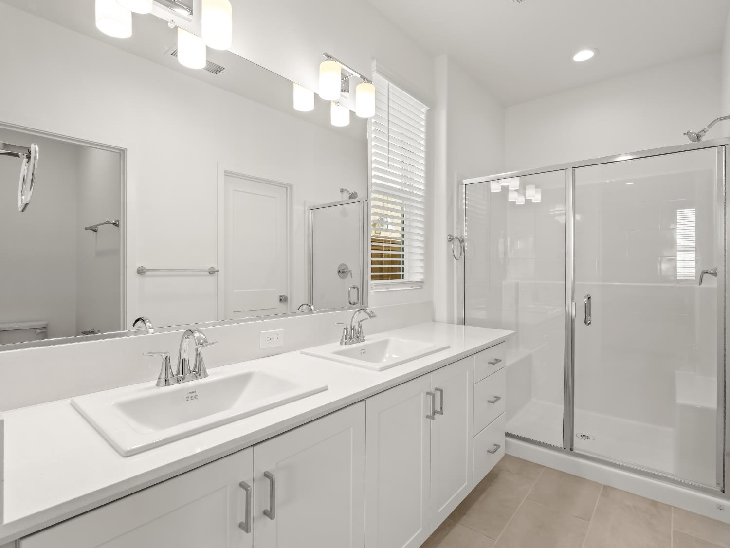 781 Elizabeth Avenue Madera, CA 93636 - Photo 16 of 31 a bathroom with double sink and a mirror