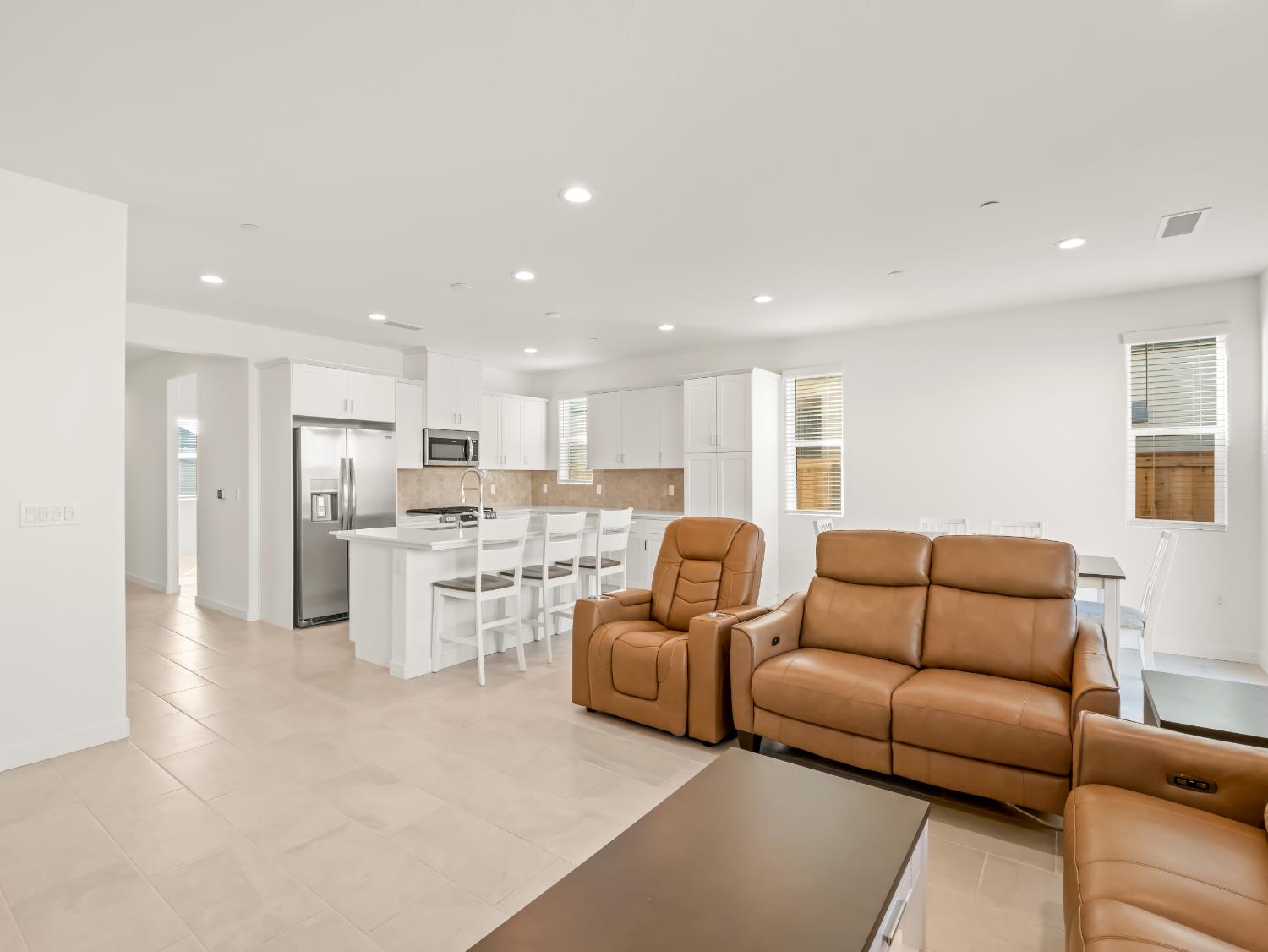 781 Elizabeth Avenue Madera, CA 93636 - Photo 20 of 31 a living room with couches and kitchen view with wooden floor