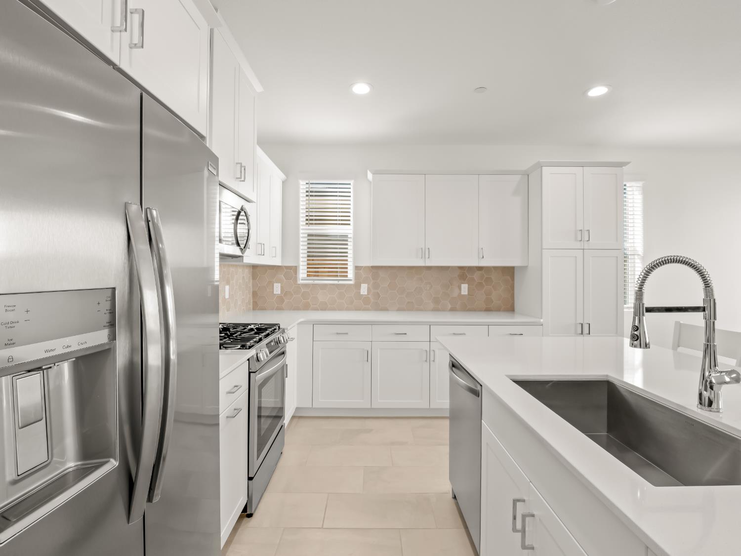 781 Elizabeth Avenue Madera, CA 93636 - Photo 6 of 31 a kitchen with stainless steel appliances granite countertop a sink stove and refrigerator