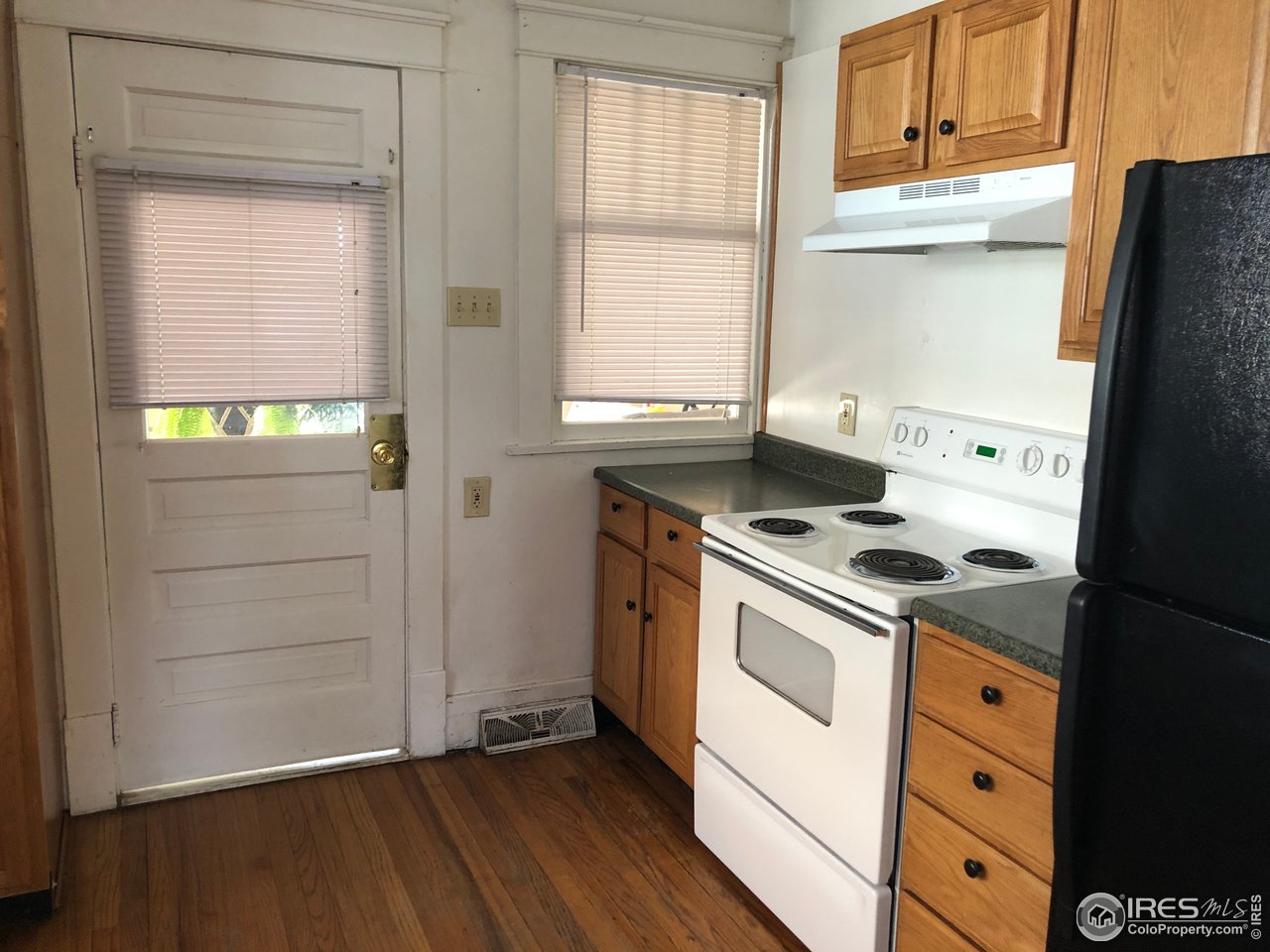 1458 10th Street Greeley, CO 80631 - Photo 8 of 21 a kitchen with a stove and a refrigerator