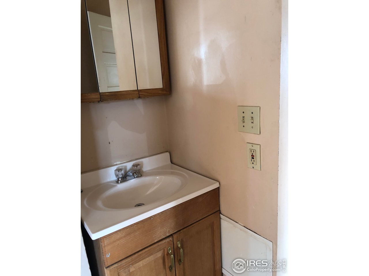 1458 10th Street Greeley, CO 80631 - Photo 10 of 21 a bathroom with a sink and a mirror