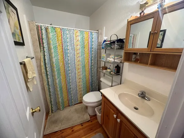 a bathroom with a sink a toilet and mirror