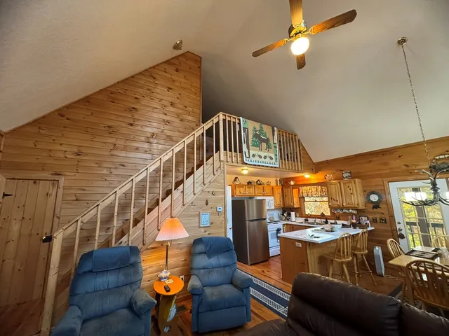 a view of a livingroom with furniture wooden floor and windows