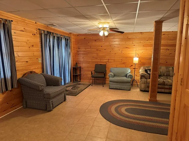 a living room with patio furniture and a chandelier