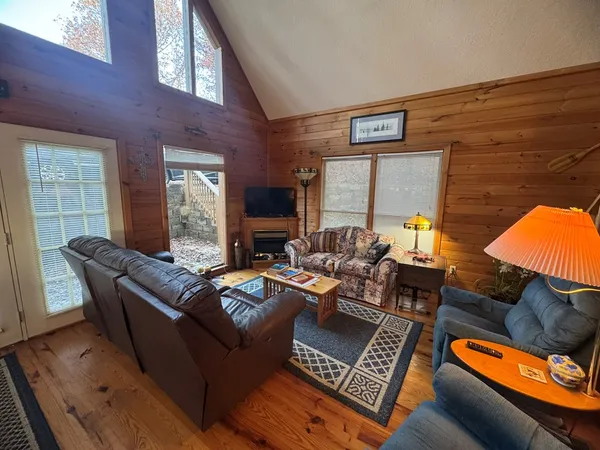 a living room with furniture and a lamp
