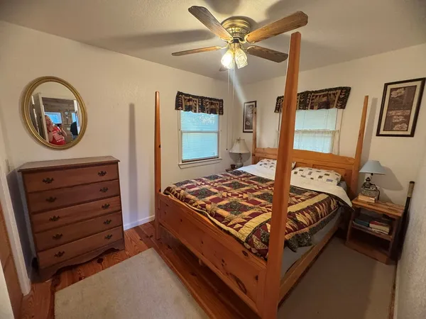 a bed sitting in a bedroom next to a window
