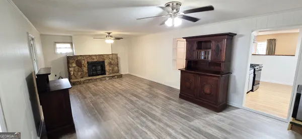 a kitchen with granite countertop a refrigerator and a stove top oven