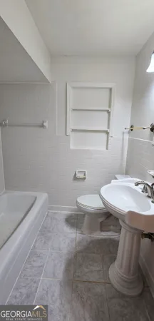 a bathroom with a sink a toilet and bathtub