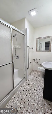 a bathroom with a granite countertop sink mirror and vanity