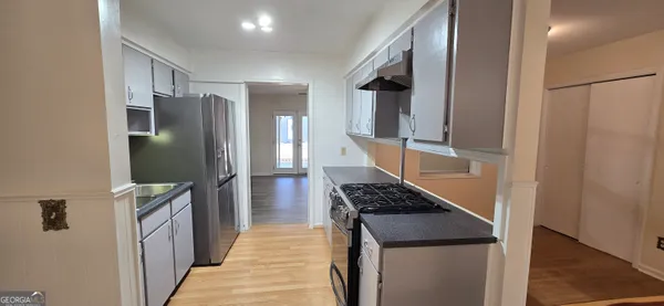 a kitchen with a refrigerator and a stove