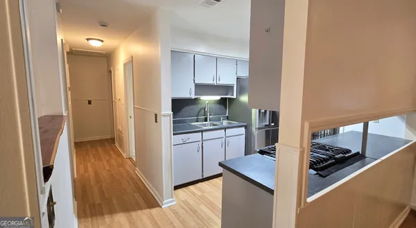 a kitchen with a refrigerator and a stove