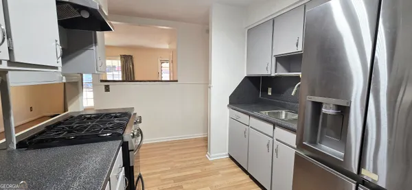 a kitchen with stainless steel appliances granite countertop a stove and a refrigerator