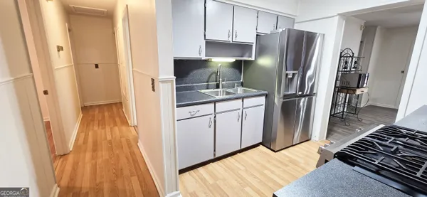 a kitchen with stainless steel appliances a refrigerator and a stove top oven