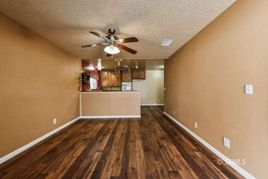 543 South Fairview Street Ridgecrest, CA 93555 - Photo 14 of 38 a view of a room with wooden floor and ceiling fan