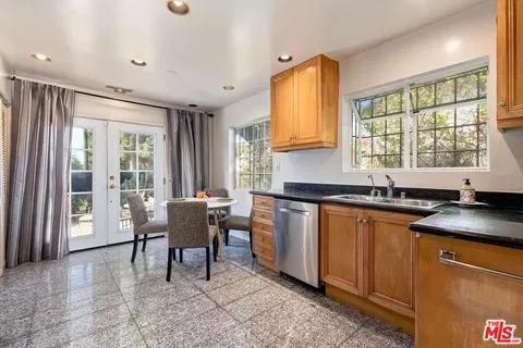 a kitchen with stainless steel appliances granite countertop sink microwave and window