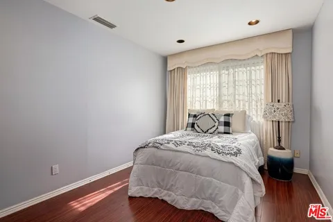 a bed sitting in a bedroom next to a window