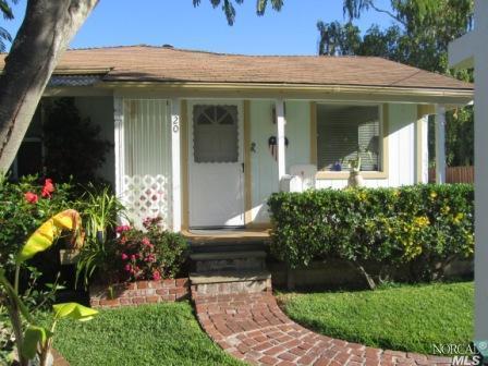 a view of a house with potted plants