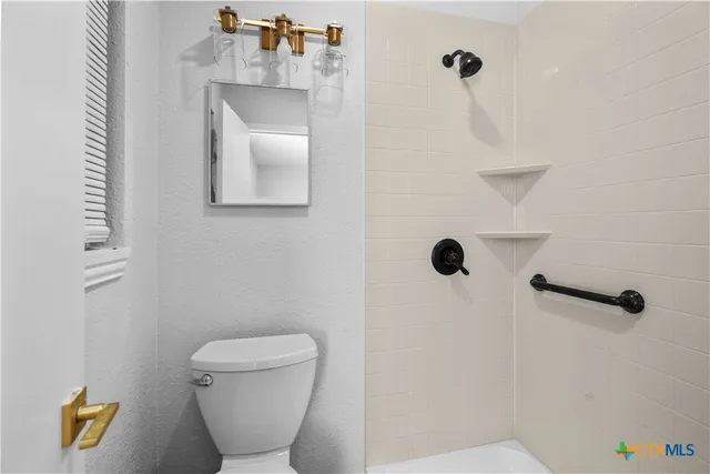 a bathroom with a toilet and a sink