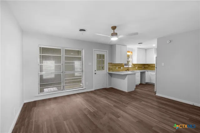a view of kitchen with wooden floor and window
