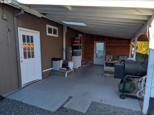 a view of living room with patio furniture and floor to ceiling window