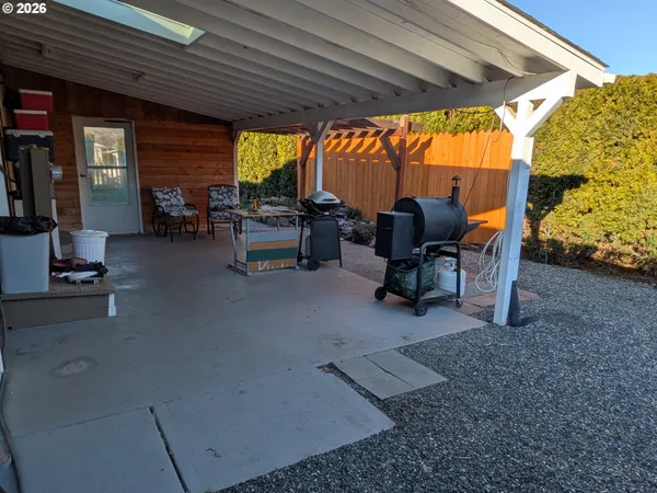 a view of a backyard with plants and outdoor seating