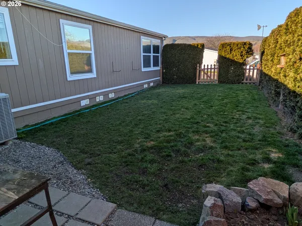 a view of a house with backyard and porch