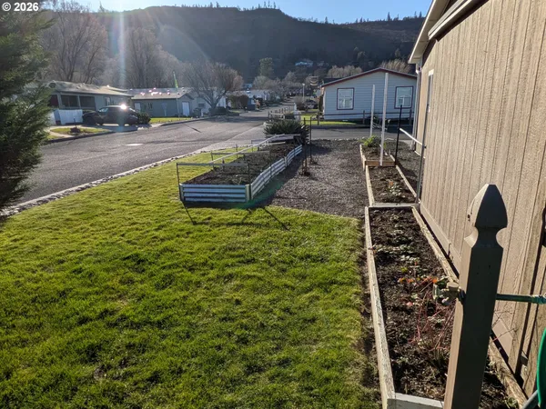 a view of a house with backyard and sitting area