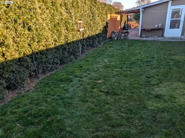 a view of backyard with seating area