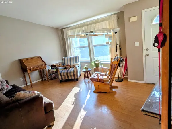 a bedroom with furniture and a large window