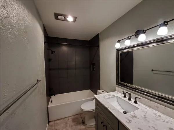 a bathroom with a sink a toilet a shower and a mirror