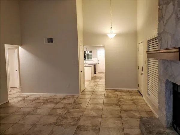 a view of hallway with a fireplace and a rug