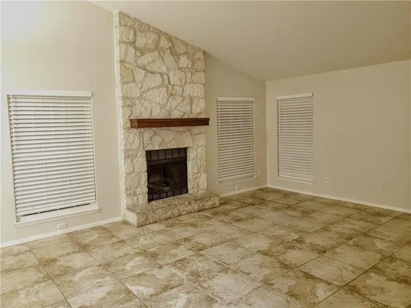 a view of an empty room with a fireplace