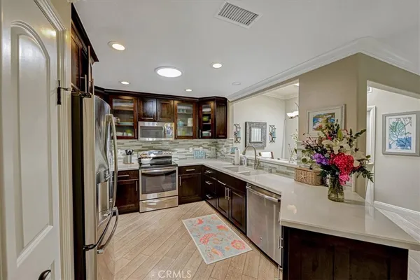 a kitchen with a sink stainless steel appliances and cabinets